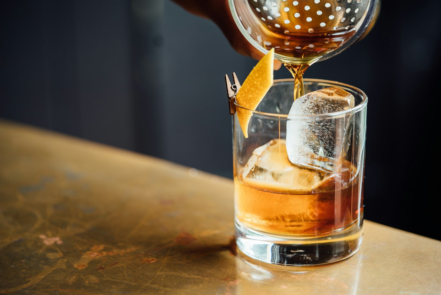 A premium spirit being poured at a bar