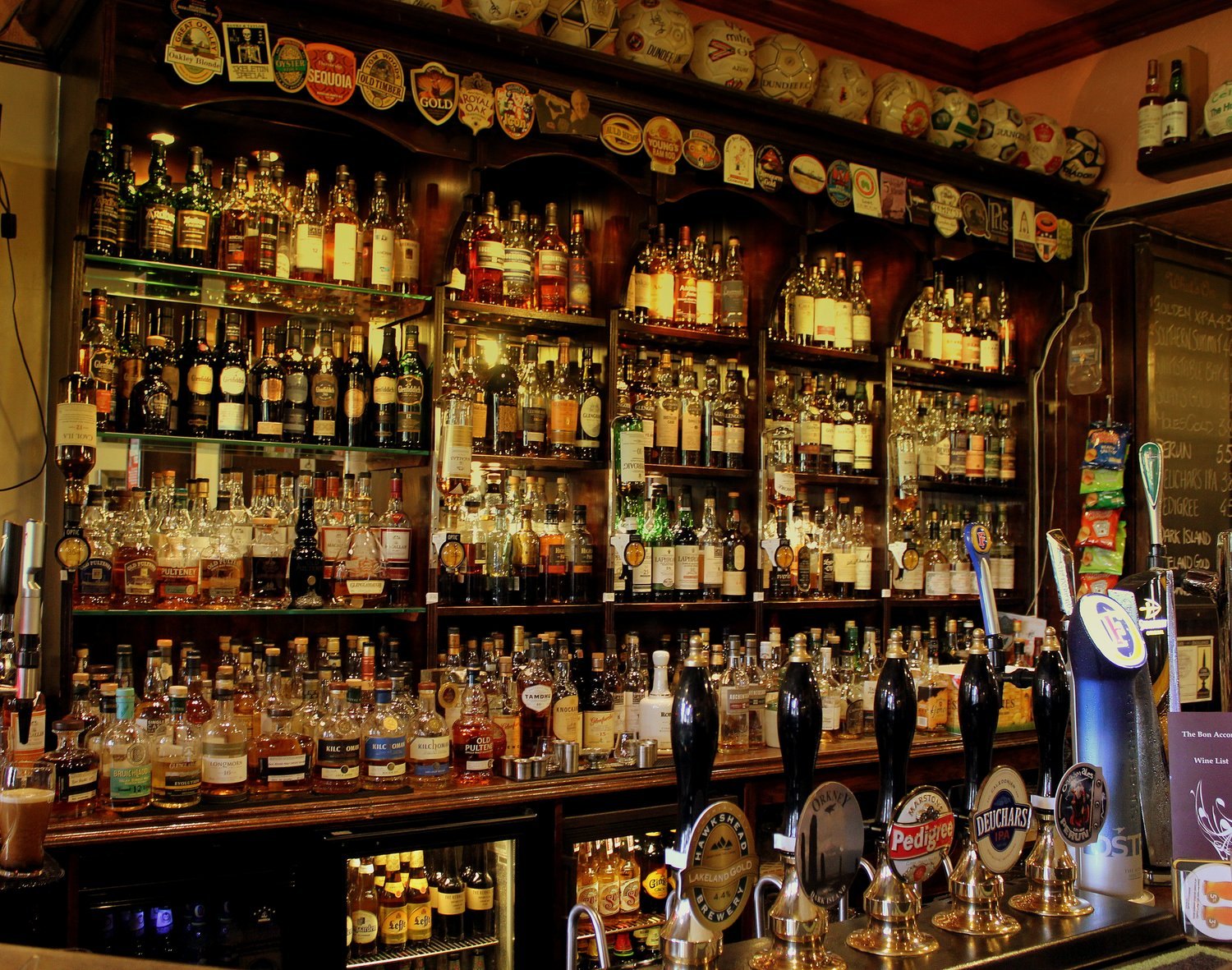 A curated wall of premium UK whisky bottles